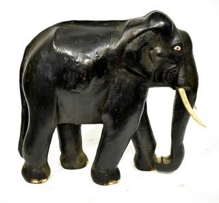 Large Asian Rosewood Carved Elephant Statue with Bone Tusks.  Measures 9" x 18" x 21". Consignor states it was an artifact in Senate Majority Leader Howard Baker's office.  