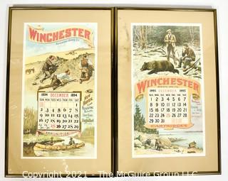 Two (2) Framed Under Glass Vintage Winchester Repeating Arms And Ammunition Calendars.  They each measure 19" long x 12".