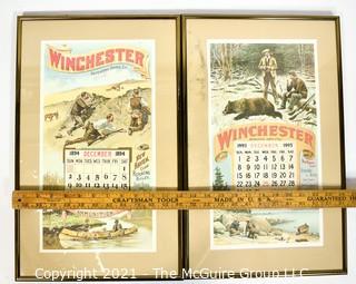 Two (2) Framed Under Glass Vintage Winchester Repeating Arms And Ammunition Calendars.  They each measure 19" long x 12".