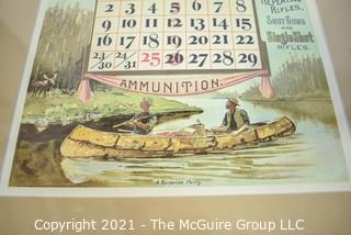 Two (2) Framed Under Glass Vintage Winchester Repeating Arms And Ammunition Calendars.  They each measure 19" long x 12".