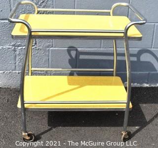 Mid Century Yellow Formica and Chrome Serving or Bar Cart on Wheels. Measures 19" x 28" x 32". 