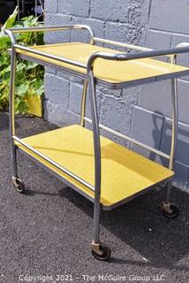 Mid Century Yellow Formica and Chrome Serving or Bar Cart on Wheels. Measures 19" x 28" x 32". 