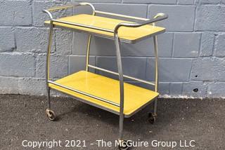 Mid Century Yellow Formica and Chrome Serving or Bar Cart on Wheels. Measures 19" x 28" x 32". 