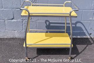 Mid Century Yellow Formica and Chrome Serving or Bar Cart on Wheels. Measures 19" x 28" x 32". 