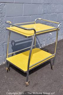 Mid Century Yellow Formica and Chrome Serving or Bar Cart on Wheels. Measures 19" x 28" x 32". 