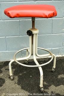 Industrial Adjustible Tubular Steel Rolling Stool with Red Vinyl Seat. 