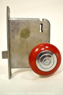 Art Deco Locking Mechanism with Red Handle Door Knob.