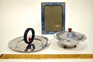 Blue Glass Mirror Frame and Two Chrome and Bakelite Serving Items.