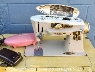 Vintage Signer Sewing Machine with Attachments in Mid Century Storage Table. 