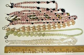 Seven (7) Strands of Mixed Stone Beads Including Bowenite, Rose Quartz and Black Faceted Glass. 