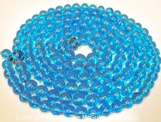 Two (2) Round Blue Glass Crystal Bead Strands.  They Measures 41" and 16".