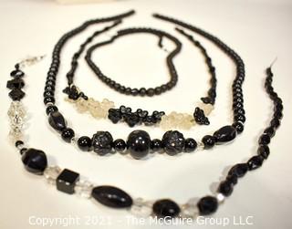 Four (4) Strands of Black Faceted Glass Beads .