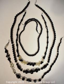 Four (4) Strands of Black Faceted Glass Beads .