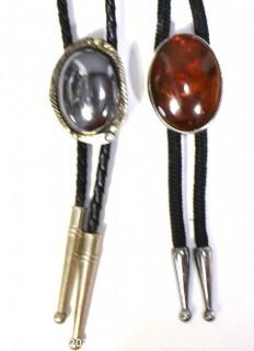 Two (2) Vintage Unmarked Sterling Silver Bolo Ties with Amber and Hematite Stones.