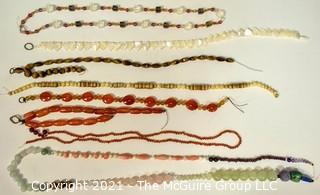 Eight (8) Strands of Mixed Stone Beads Including Carnelian, Mother of Pearl, Tigers Eye, Bone. 