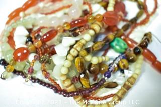 Eight (8) Strands of Mixed Stone Beads Including Carnelian, Mother of Pearl, Tigers Eye, Bone. 