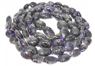 One (1) Carved Oval Amethyst Strand of Beads.  Measures 40".