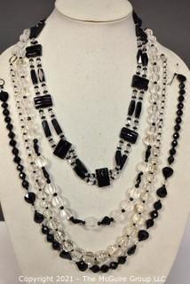 Four (4) Clear and Black Faceted Black Bead Strands. 