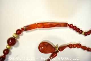 Two (2) Strands of Beads Including Carnelian and Red Jasper.  One bead broken.  They measure 21" & 22" long 