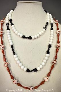 Two (2) Strands of Porce;ain with Red Jasper Beads and White with Black Glass Beads.  They measure 23" and 46".