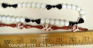 Two (2) Strands of Porce;ain with Red Jasper Beads and White with Black Glass Beads.  They measure 23" and 46".