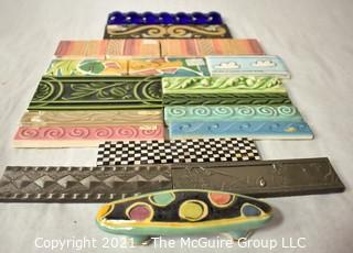 Group of Ceramic Hand Painted Tile Trims Border Pieces in Various Patterns.  Includes one Broken Tile. 