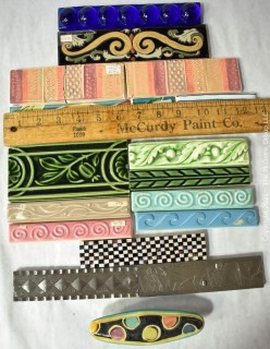 Group of Ceramic Hand Painted Tile Trims Border Pieces in Various Patterns.  Includes one Broken Tile. 