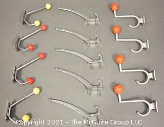 Group of Mid Century Aluminum Wall Hooks with Red and Yellow Wood Knobs.