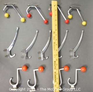 Group of Mid Century Aluminum Wall Hooks with Red and Yellow Wood Knobs.