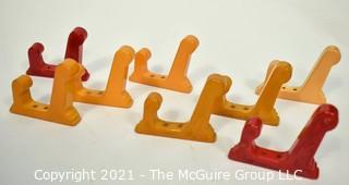 Set of Eight (8) Vintage Bakelite Wall Hooks in Butterscotch and Cherry Red.  Each measures 3" long.