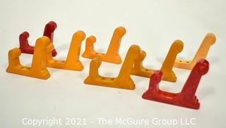 Set of Eight (8) Vintage Bakelite Wall Hooks in Butterscotch and Cherry Red.  Each measures 3" long.