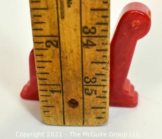 Set of Eight (8) Vintage Bakelite Wall Hooks in Butterscotch and Cherry Red.  Each measures 3" long.