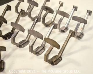 Eleven (11) Aluminum Art Deco Mid Century Wall Hooks.  Each measure 8" long.