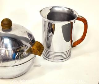 Collection of Mid Century Art Deco Style Chrome Barware.  Includes Chase Tall Cocktail Shaker With Butterscotch Bakelite Top, West Bend Penguin Hot & Cold Server, Bakelite Handled Pitcher and Small Pitcher with Wrapped Handle. 