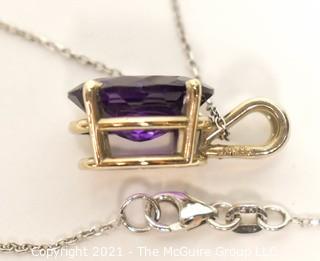 Oval Faceted Amethyst Pendant in 14k Yellow Gold Surround on 18" Chain.