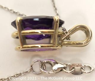 Oval Faceted Amethyst Pendant in 14k Yellow Gold Surround on 18" Chain.