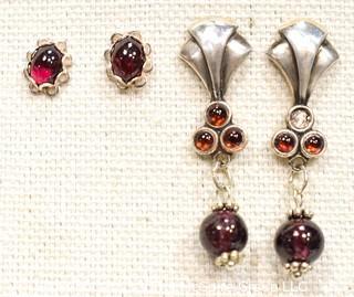 Two Pairs of Sterling Silver and Garnet Pierced Earrings.  One missing small stone. 