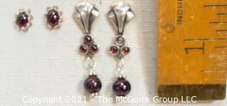 Two Pairs of Sterling Silver and Garnet Pierced Earrings.  One missing small stone. 