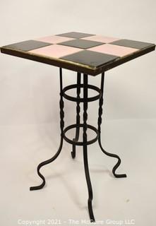 Vintage Wrought Iron Table with Pink and Black Tile Insert. Measures 15" tall and 23" square.