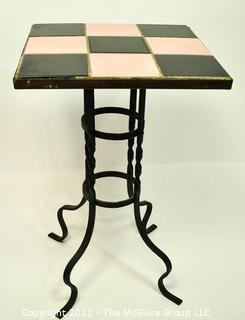 Vintage Wrought Iron Table with Pink and Black Tile Insert. Measures 15" tall and 23" square.