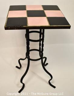 Vintage Wrought Iron Table with Pink and Black Tile Insert. Measures 15" tall and 23" square.