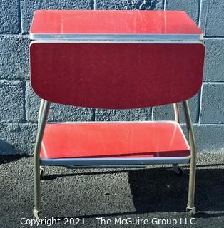 Vintage Mid Century Red  Formica Top Drop Leaf Table with Chrome Trim on Casters. 35" wide when leaves up, 39" tall. Some separation on Formica top. *