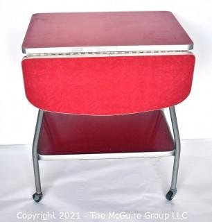 Vintage Mid Century Red  Formica Top Drop Leaf Table with Chrome Trim on Casters. 35" wide when leaves up, 39" tall. Some separation on Formica top. *