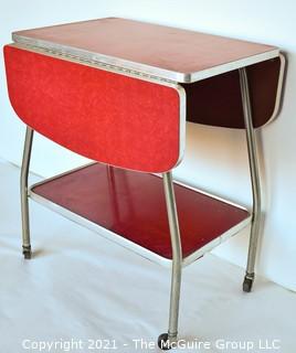 Vintage Mid Century Red  Formica Top Drop Leaf Table with Chrome Trim on Casters. 35" wide when leaves up, 39" tall. Some separation on Formica top. *