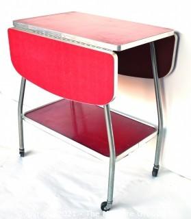 Vintage Mid Century Red  Formica Top Drop Leaf Table with Chrome Trim on Casters. 35" wide when leaves up, 39" tall. Some separation on Formica top. *