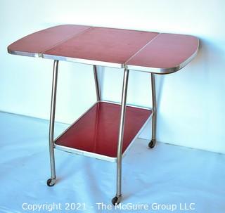 Vintage Mid Century Red  Formica Top Drop Leaf Table with Chrome Trim on Casters. 35" wide when leaves up, 39" tall. Some separation on Formica top. *