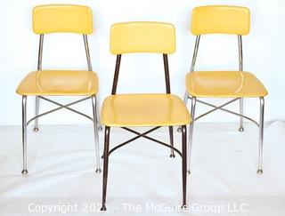 Three (3) Mid Century Modern Heywood Wakefield Woodite Solid Plastic Yellow and Chrome School Chairs. 