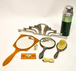 Collection of Art Deco Decorative Items Including Dresser Brush and Hand Mirror Set, One in Butterscotch Bakelite, Chrome Architectural Salvage Piece, Thermos, Toy Car, Ink Stand, and Crystal Globe Clock. 