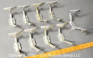 Nine (9) Aluminum Art Deco Mid Century Wall Hooks. Each measure 8" long.