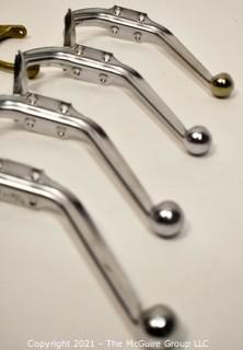 Eight (8) Aluminum and Brass Wall Hooks. Various Lengths.